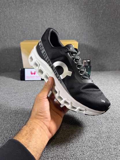 On Cloudmonster 2 running shoes in black and white