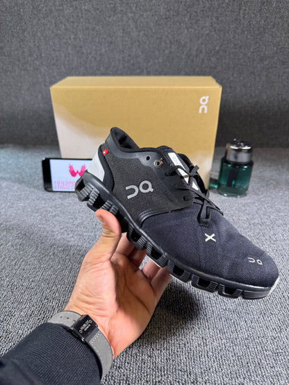 This is a pair of On Cloud X 3 sneakers in black