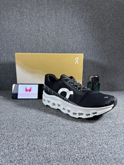 On Cloudmonster 2 running shoes in black and white